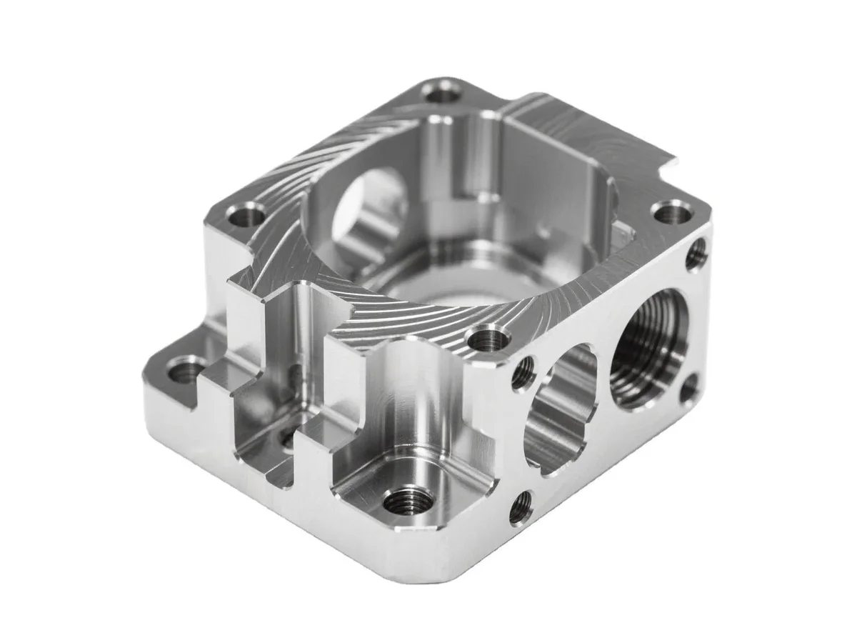 Custom CNC milled aluminum manifold block with deep pockets threaded ports and machined faces