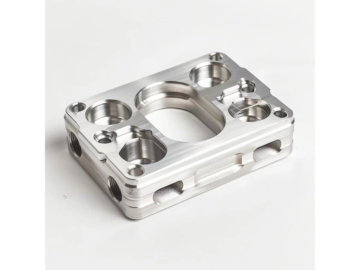 Custom CNC milled aluminum mounting plate with precision bores pockets and bolt holes
