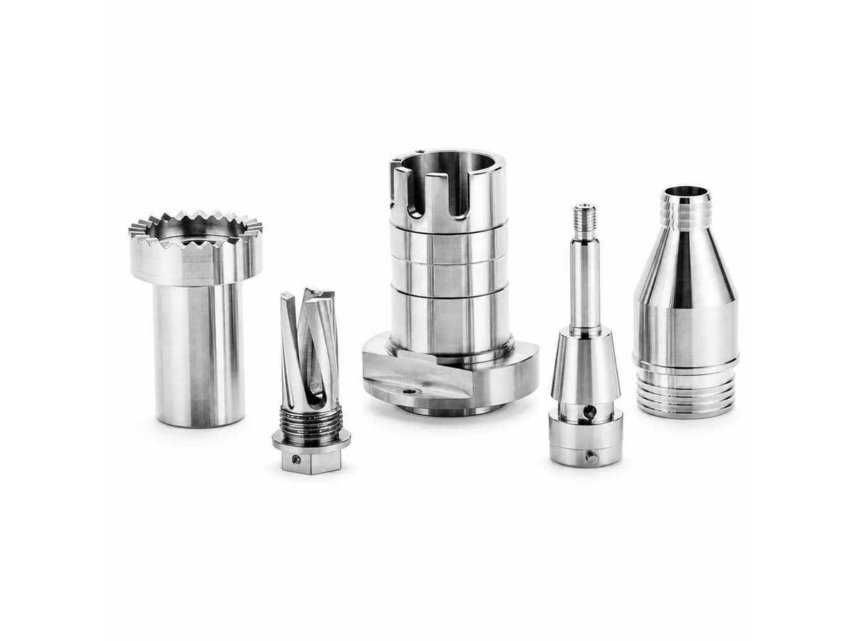 Custom CNC turning prototypes and tooling components with stepped bores slots and external threads on a pure white background