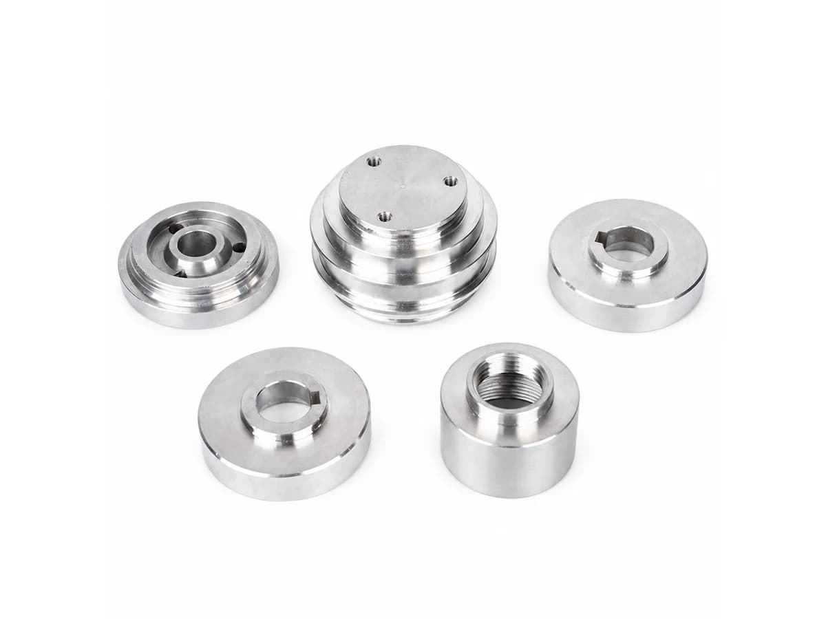 Precision CNC turning pulley components rollers and grooved wheels with keyways on a pure white background