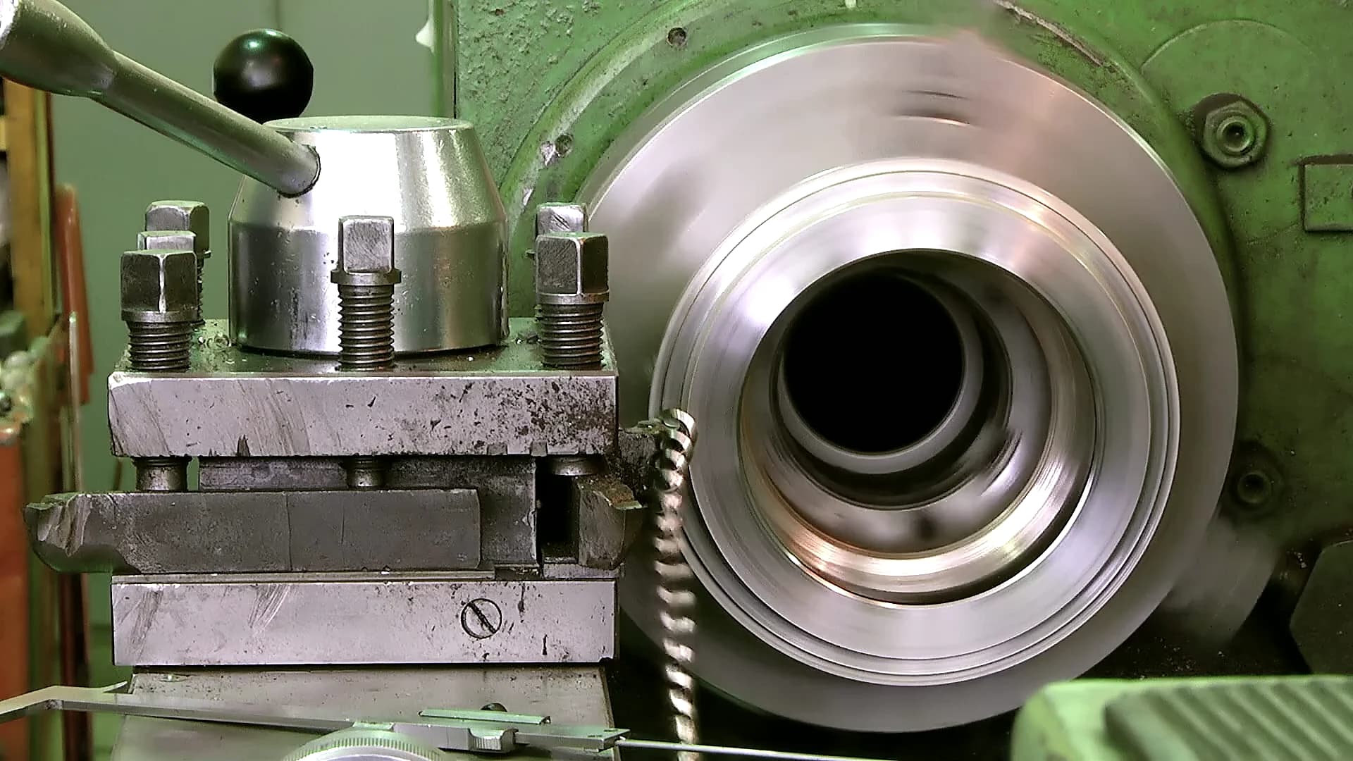 Steel workpiece rotating beside a cutting tool during a precision turning process