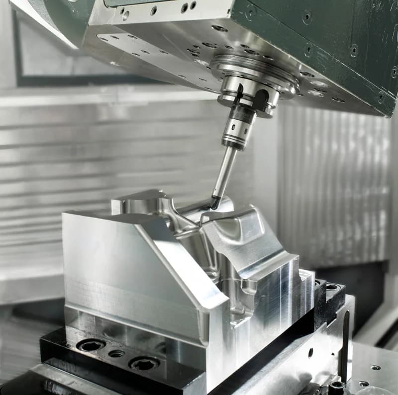 Five-axis CNC machining process cutting a complex aluminum metal part