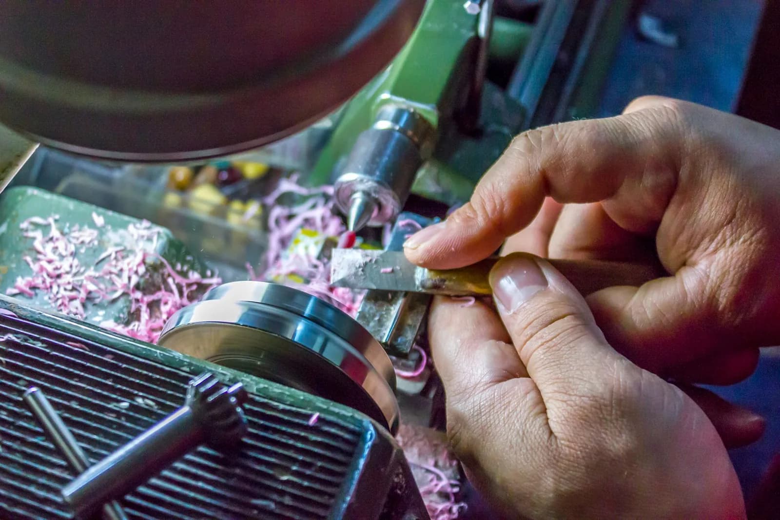 Machinist performing a precision metal lathe turning operation