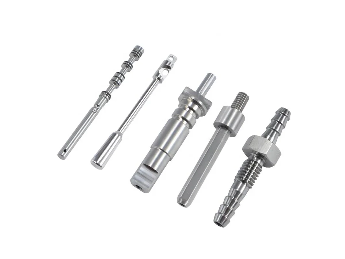 Miniature Swiss CNC machined pins shafts and threaded stainless steel components on white
