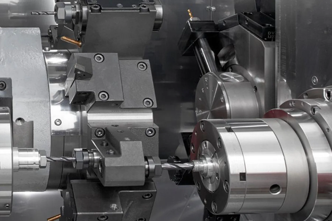 Inside a Swiss CNC lathe showing live tooling spindle and small-part machining zone