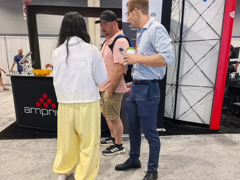Custom CNC machined components displayed during an IMTS booth demonstration