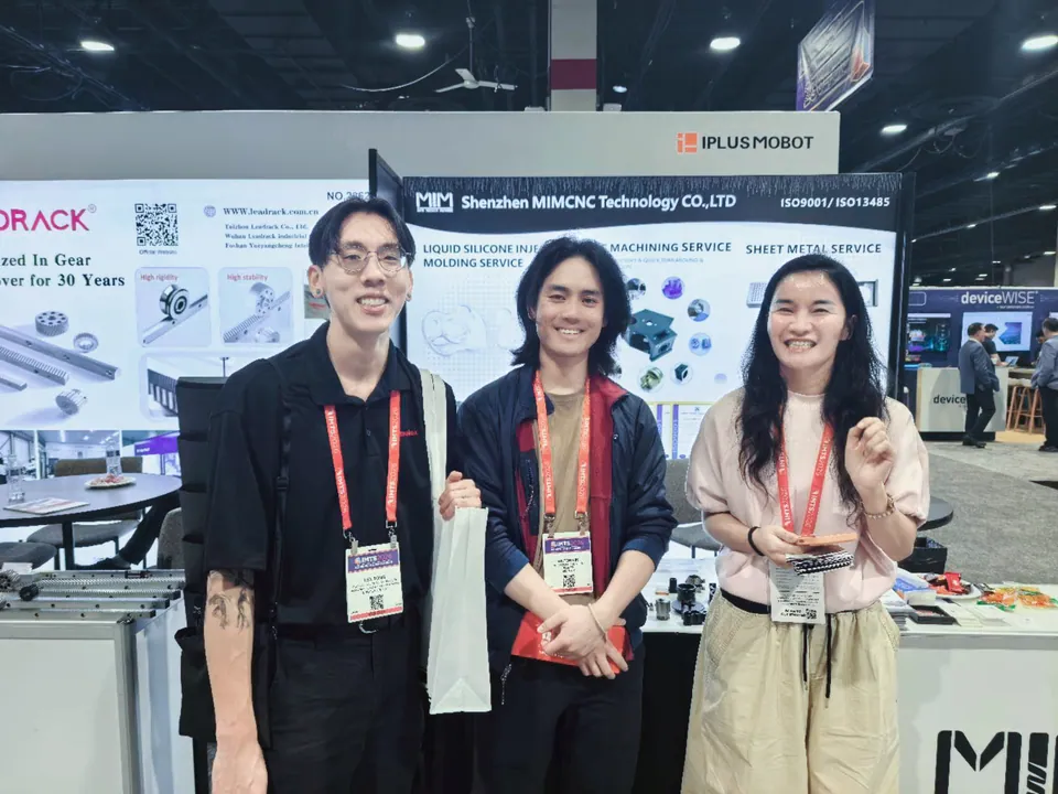 Engineering and manufacturing team meeting at the MIM Machining IMTS booth