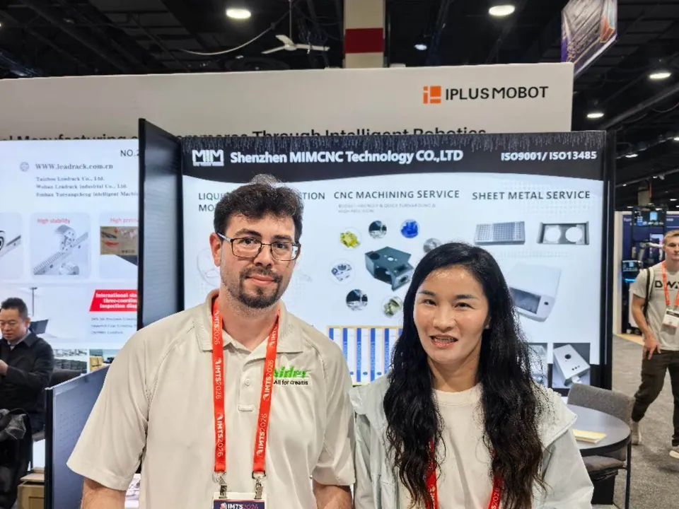 Precision machining project discussion with an attendee at the MIM Machining IMTS booth