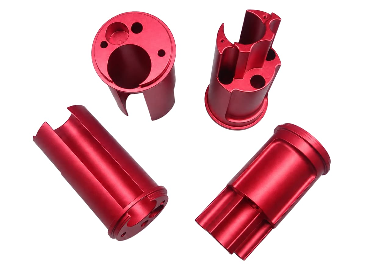 Red anodized CNC machined aluminum parts on a white background