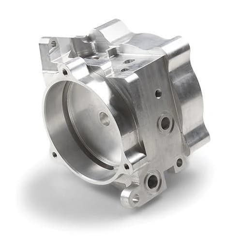 Precision CNC machined aluminum engine housing with large bore and bolt pattern on a white background