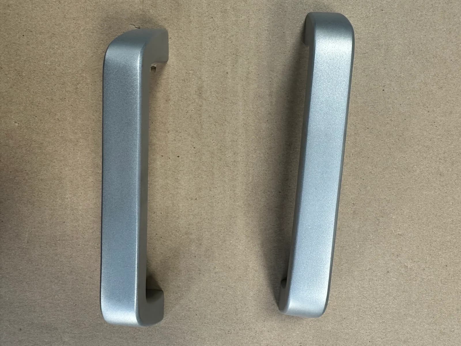 Custom aluminum die cast handles with a uniform metallic finish