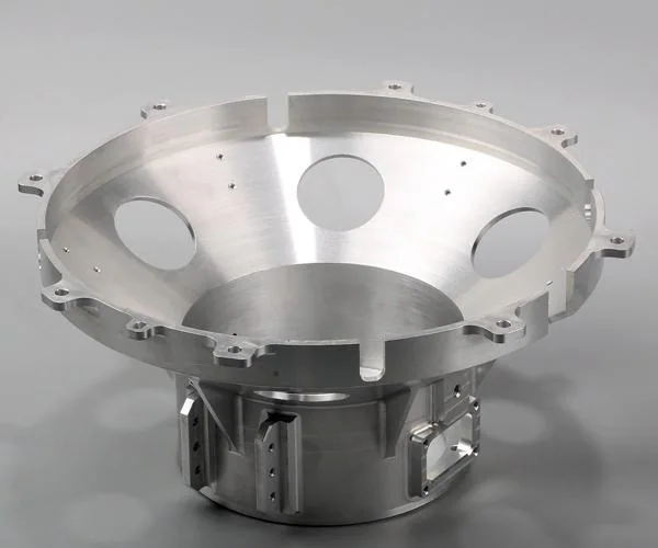 Heavy CNC machined large silver machine housing with a deep circular cavity and mounting flange