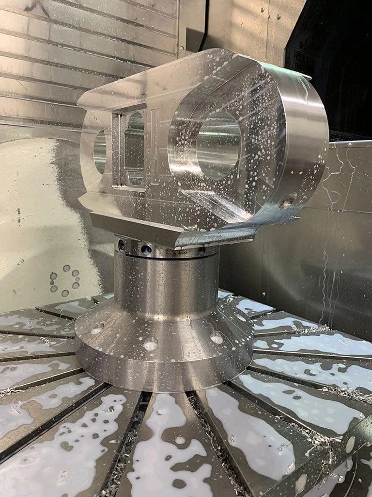 Heavy CNC machining of a large metal workpiece with coolant and multi-face access