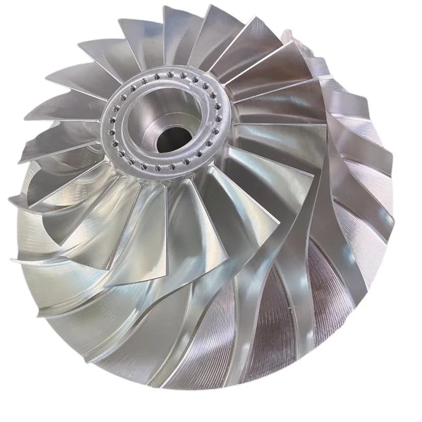 Large CNC machined silver turbine impeller with curved blades and central bore on a white background