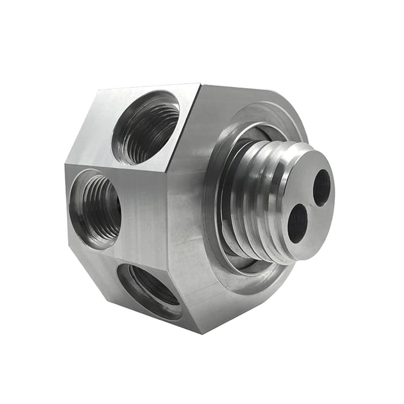 Precision CNC machined silver threaded manifold with radial ports milled flats and external thread on a pure white background