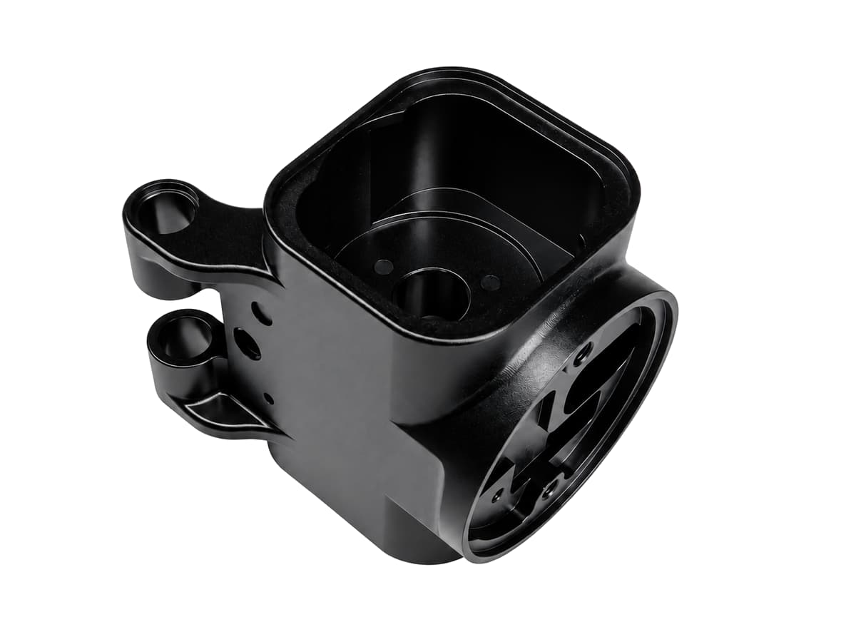 Black surface-finished precision housing on a white background