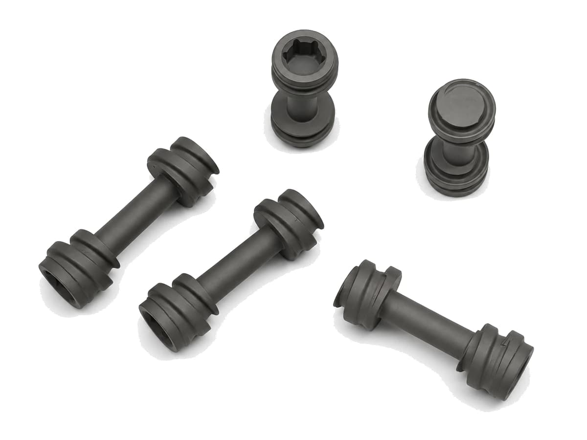 Five gray titanium alloy CNC machined medical shaft components on a pure white background